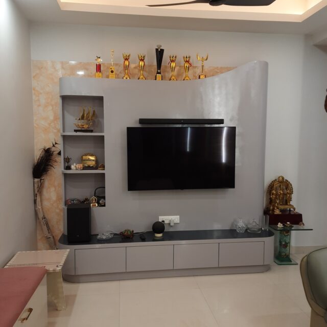 Drawing room designed and executed for a client at the Irish Pearls, Greater Noida. Combining cool elegance and warm homely vibes, created by the use of subtle colors and minimalist elements, highlighted by the use of LED strips and downlighters that can be used in various permutations and combinations to create an interesting ambience each time they are switched on or off. #interiordesign #drawingroom #tvunit
